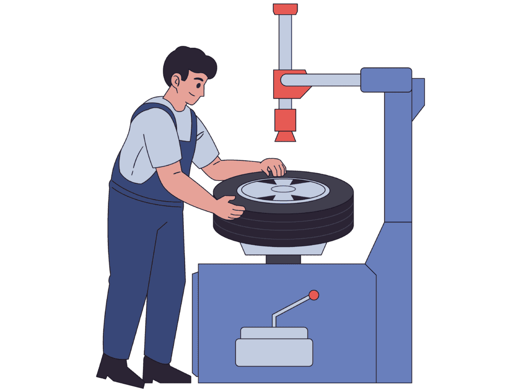 Mecànic de pneumàtics treballant en un taller.